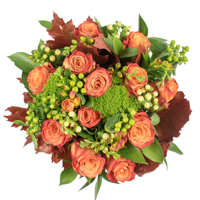 From a direct overhead perspective this bouquet reads as an autumnal study in colour and texture, composed with care and a nod to the season's palette. The focal blooms are robust roses in a spectrum from soft peach through coral to vivid orange, many showing an elegant bicolour effect where inner petals are gently lighter and outer petals carry a richer, russet-tinted rim. Interspersed are clusters of Hypericum berries-some a lively lime-green and others a pale, buttery cream-whose round, glossy surfaces add crisp points of contrast and a slightly playful rhythm to the arrangement. Complementing these are dense, cushiony heads of green trick dianthus, their feathery, moss-like appearance introducing a verdant, almost woodland texture against the roses' smoothness. Large, lobed leaves in deep burgundy and burnt sienna are placed like small, dried-maple accents, lending an autumnal rusticity that anchors the piece, while abundant fresh green foliage fills and softens edges for a full, harmonious silhouette. The bouquet's compact, circular design allows soft light to graze the roses and throw delicate shadows, enhancing the tactile richness and depth. There is an implied fragrance of warm roses and damp greenery that evokes a walk through an October market and makes this arrangement suited for a Thanksgiving centrepiece, a heartfelt housewarming gift, or a table decoration for seasonal gatherings in and around Stamford Hill and Clapton Common.