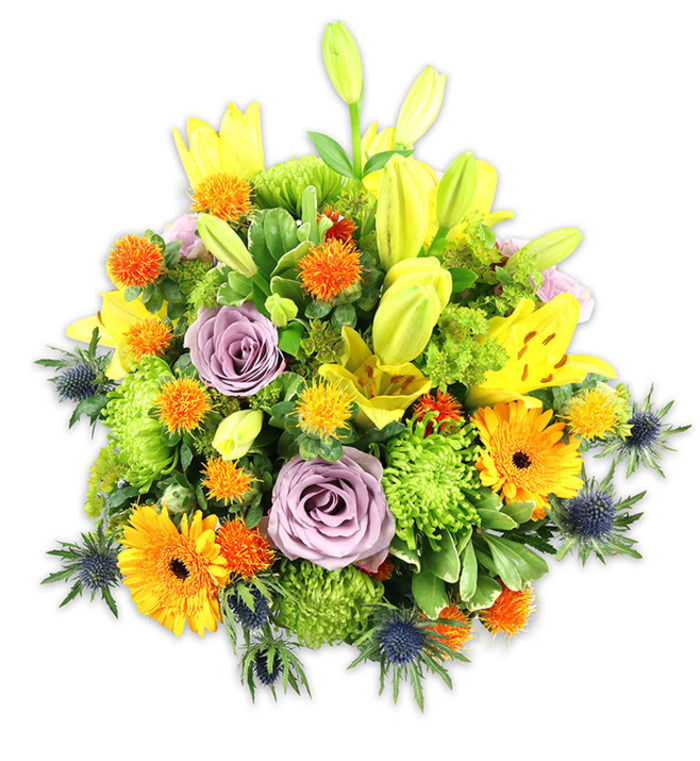 Presented against a pristine white background, this vibrant, densely packed bouquet feels both celebratory and quietly elegant, each flower placed to create rhythm and depth. Radiant yellow Asiatic lilies draw immediate attention - their open blooms exposing freckled throats and graceful stamens, while unopened buds reach skyward and promise further bloom. Soft lavender-purple roses sit centrally, their classic spiral of petals offering a soothing, romantic anchor amid the livelier colours. Cheerful orange Gerbera daisies fan outward like little suns, their dark centres adding contrast, and small spherical orange and golden accent blooms scatter delightful points of texture throughout the arrangement. The generous use of lime-green button chrysanthemums builds a lush, almost moss-like foundation, their ruffled heads filling gaps and giving the bouquet a satisfying volume. Interspersed foliage - broad lily leaves and varied glossy greens - provides a verdant framework, and several cool blue-grey sea thistles (Eryngium) emerge along the sides and lower edge to introduce an unexpected, architectural coolness. Under gentle studio lighting the petals glow and leaf surfaces catch soft highlights, suggesting fresh-cut fragrance and immediate presence. I imagine this piece arriving as a centerpiece for a Stamford Hill dinner, a bright anniversary gift on a table near Lordship Road, or sent to convey appreciation to a neighbour - its textures and colours working together to communicate warmth, optimism, and thoughtful care.